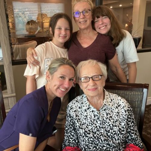 Group of residents and staff smiling together.