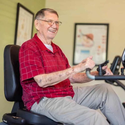 Senior resident exercising with a smile
