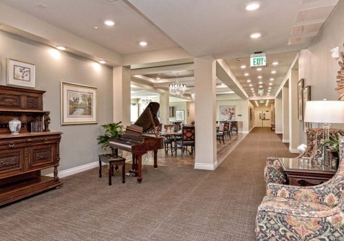 Interior view of a common area with a piano and seating