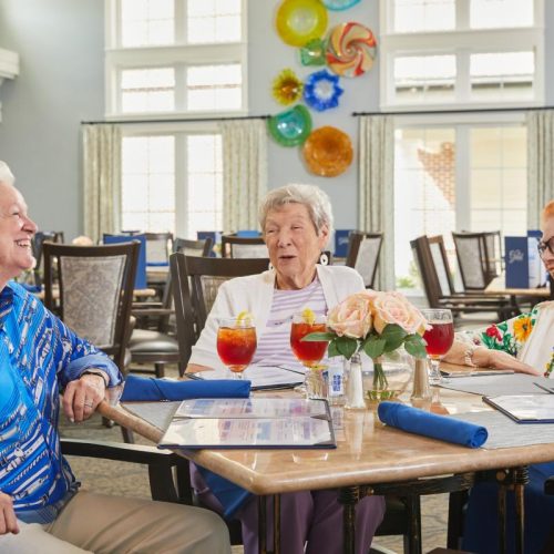 Residents enjoying drinks in a dining area.