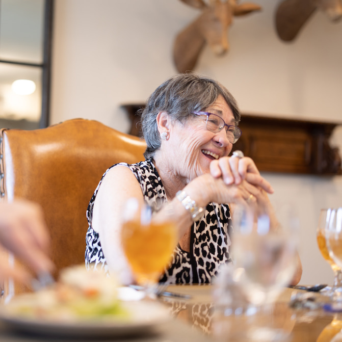 Senior resident enjoying a meal in the dining room.
