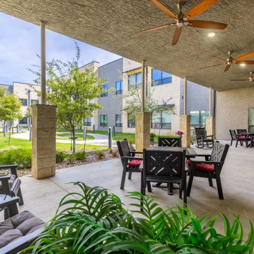 Outdoor seating area with plants and tables