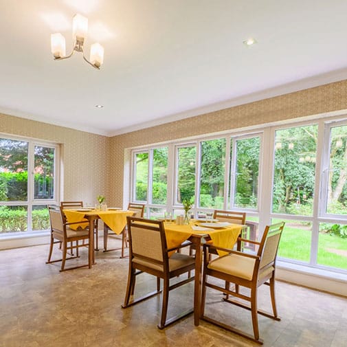 Dining area with chairs and tables by large windows