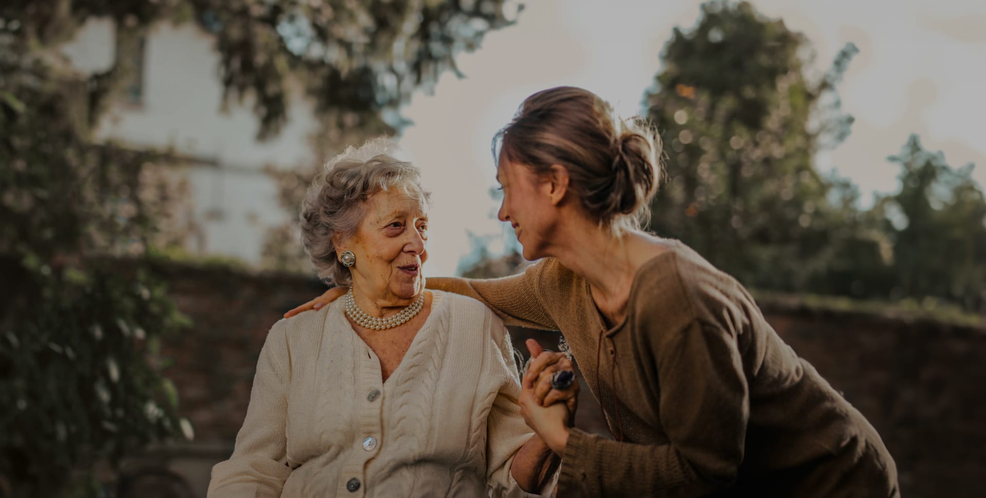 Resident and staff member enjoying conversation outdoors