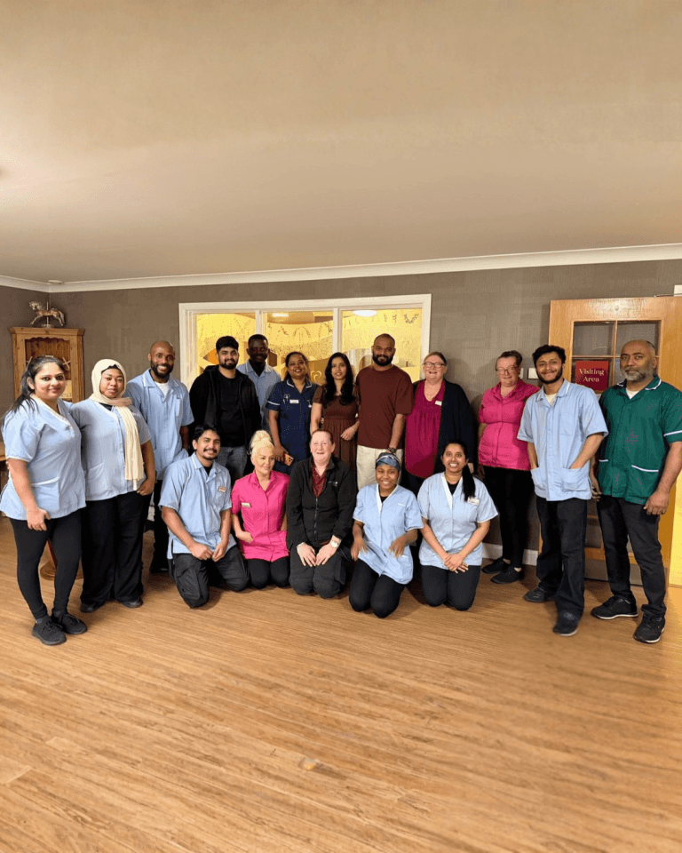Staff members smiling in a common area