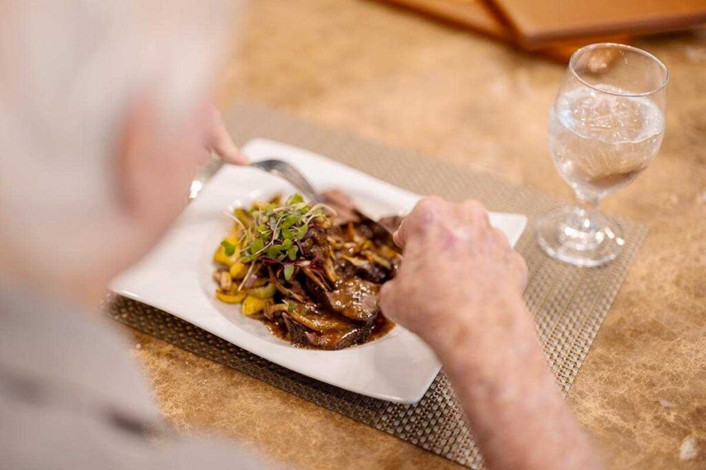 An elderly person enjoying a meal