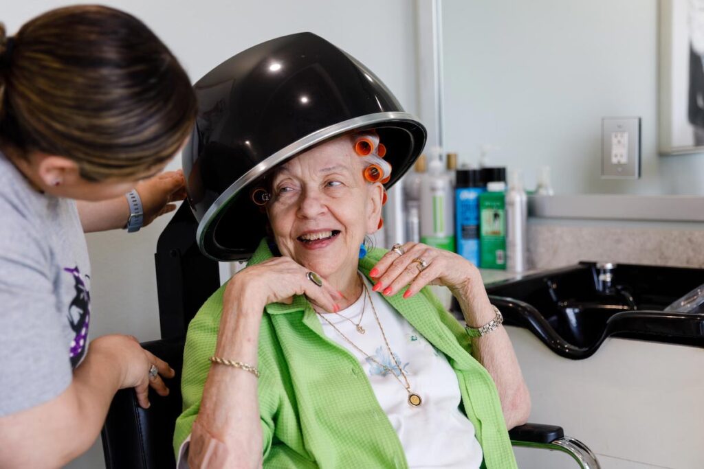 Resident enjoying a salon treatment with staff