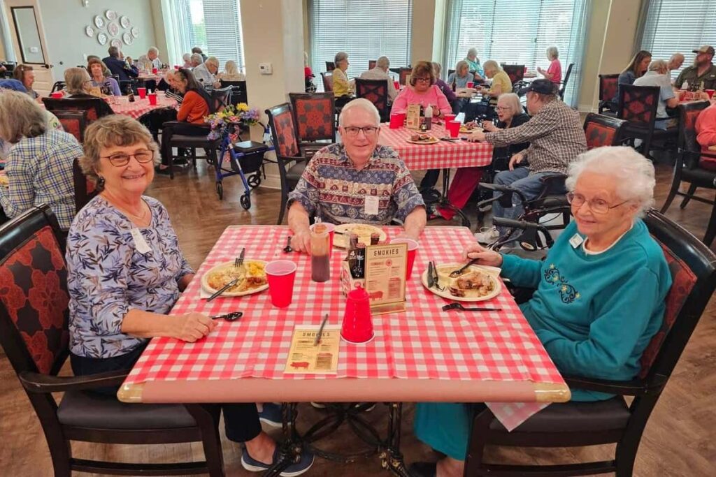 Residents enjoying a meal together in the dining room.