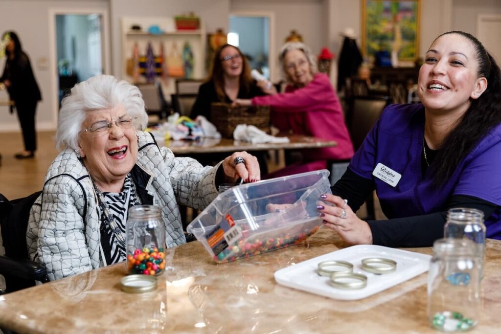 Residents and staff enjoying a playful activity together.