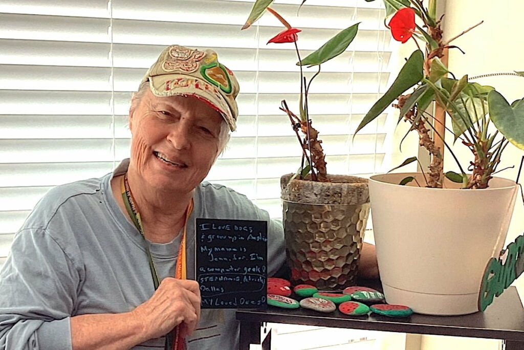 Resident holding a message board with plants
