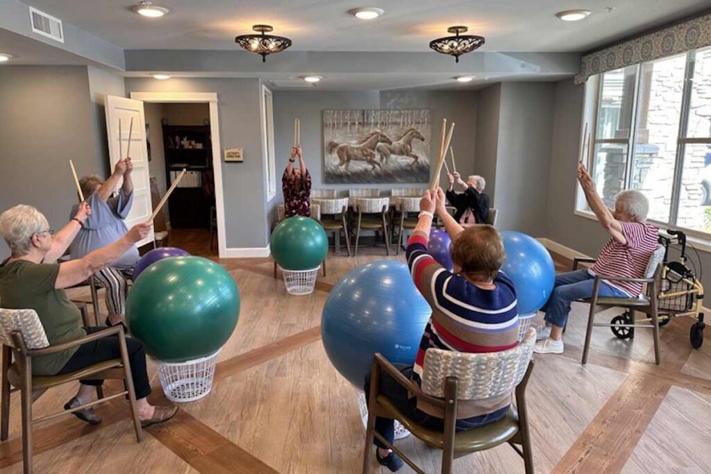 Residents participating in a fitness activity with exercise balls.