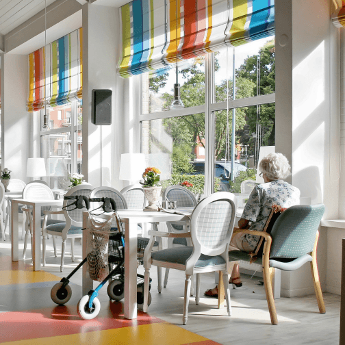 Bright common area with a resident and tables