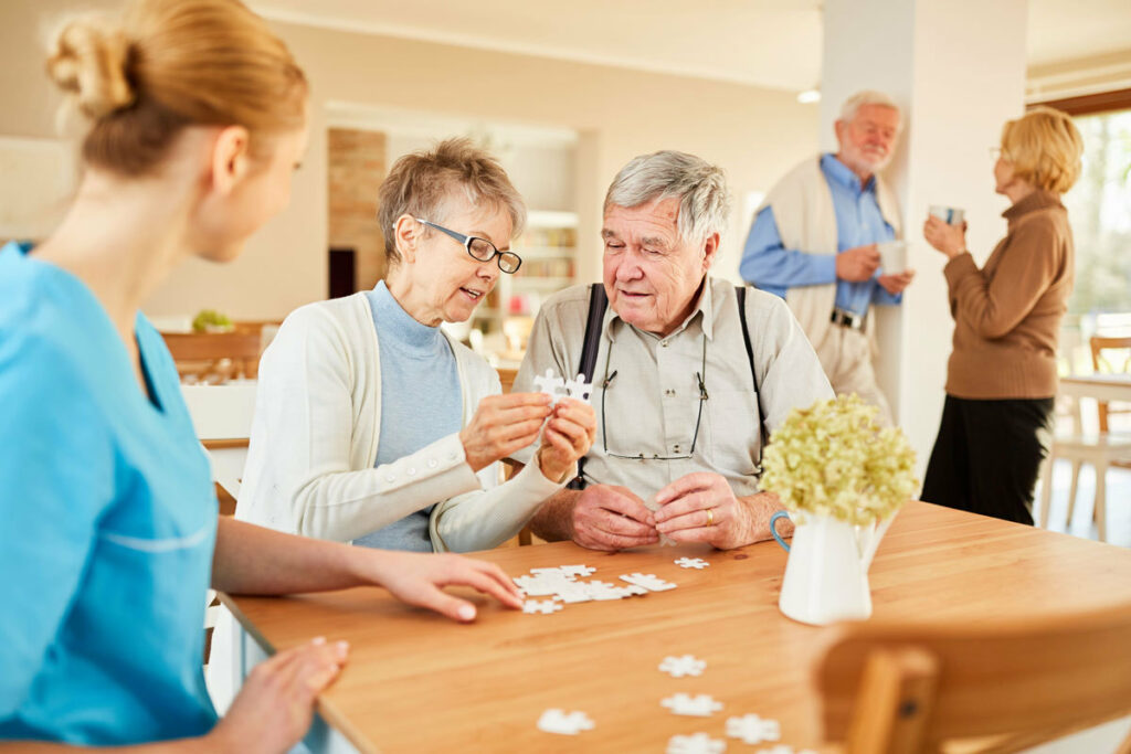 Residents and staff engaging in a puzzle activity