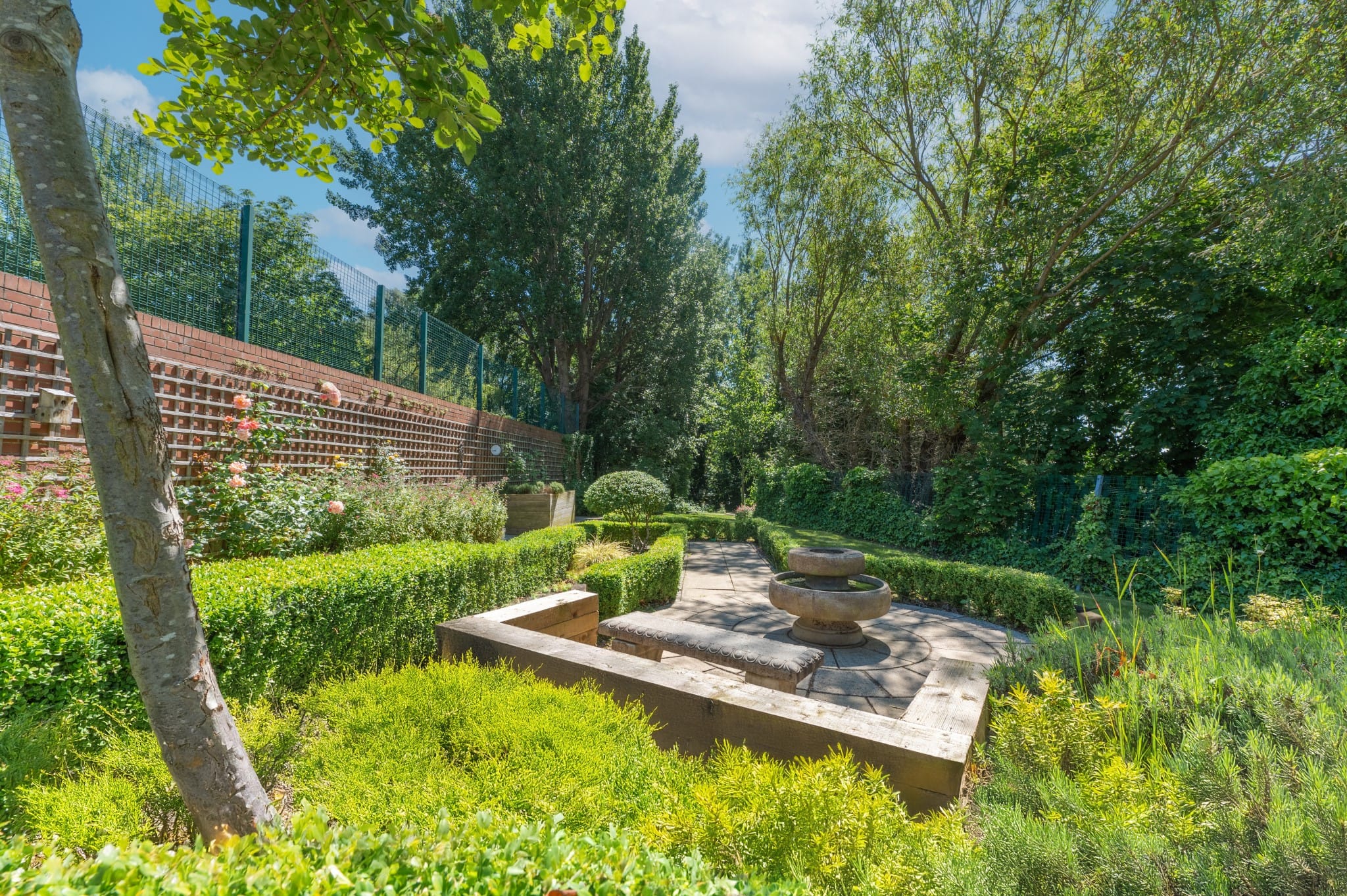 Serene garden area with greenery and seating