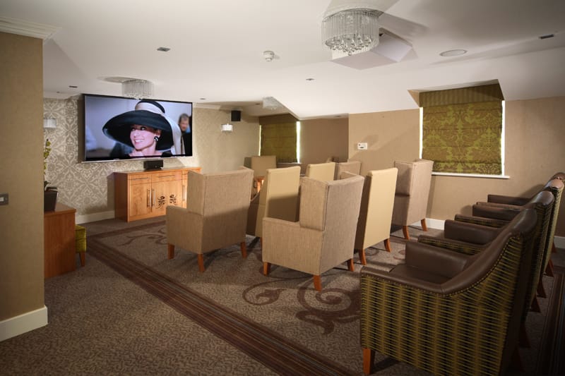 Cozy common area with seating and a large TV.