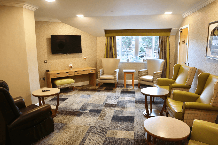 Cozy common area with seating and windows.