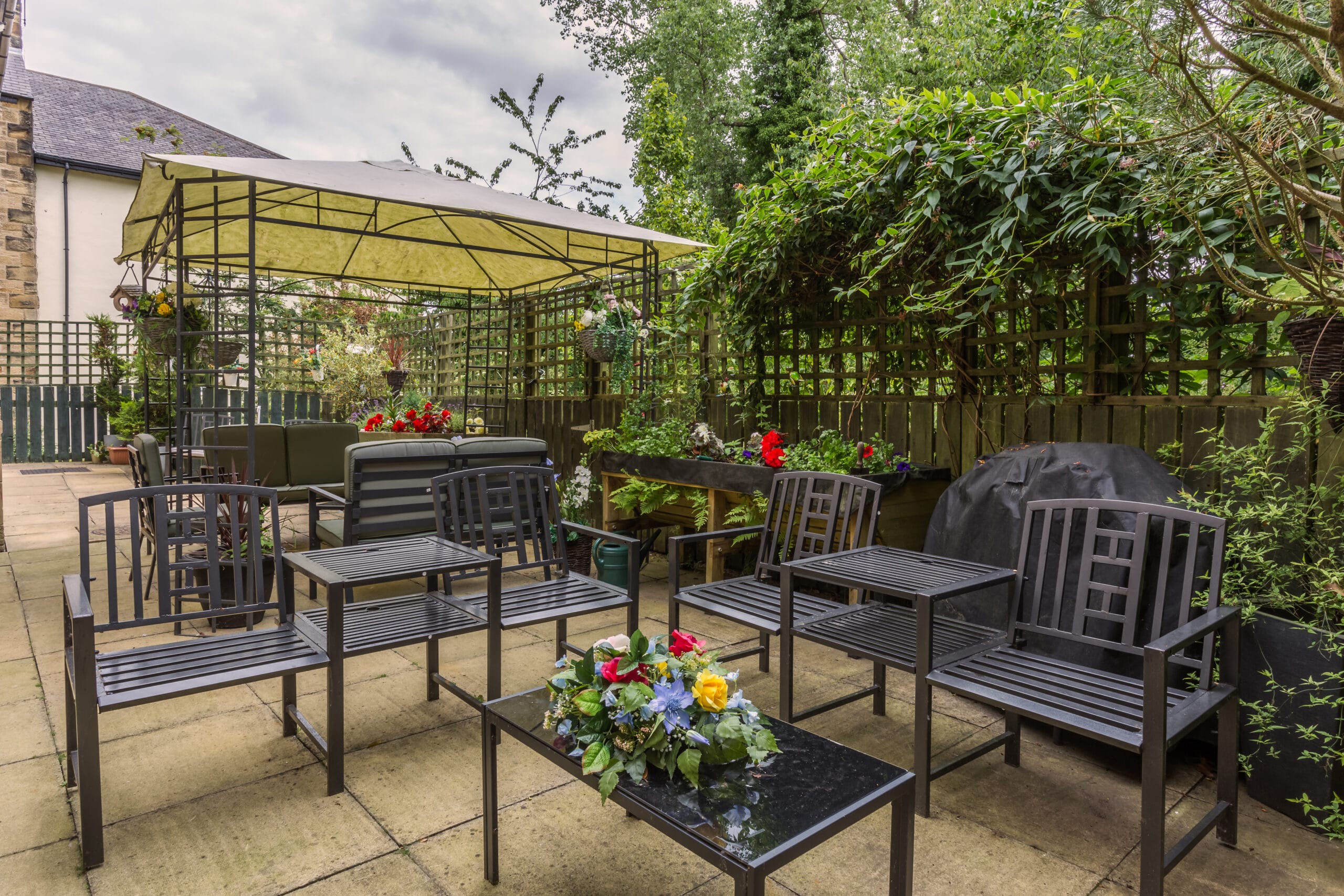 Outdoor seating area with flowers and canopy