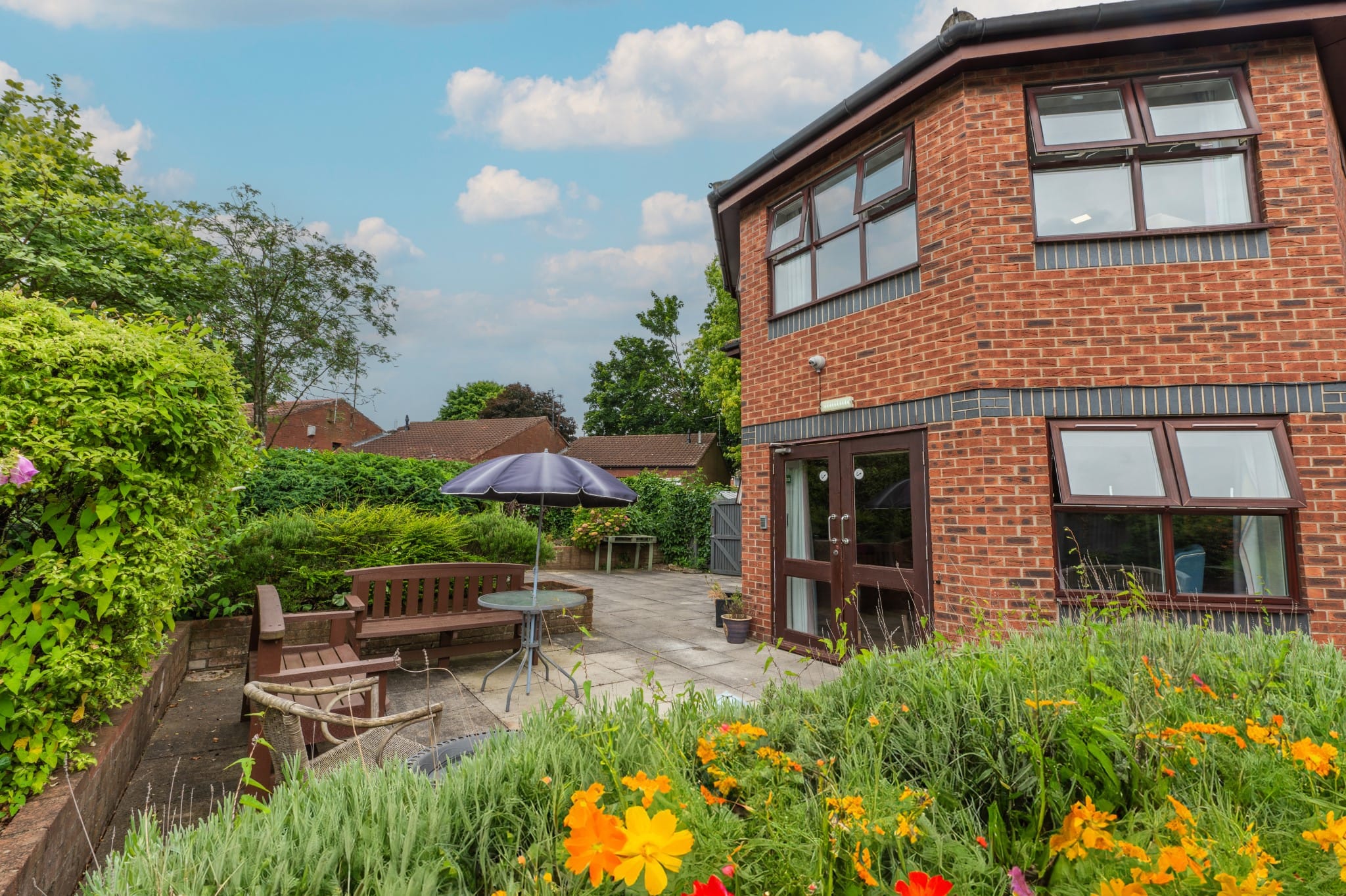 Outdoor patio area with seating and flowers