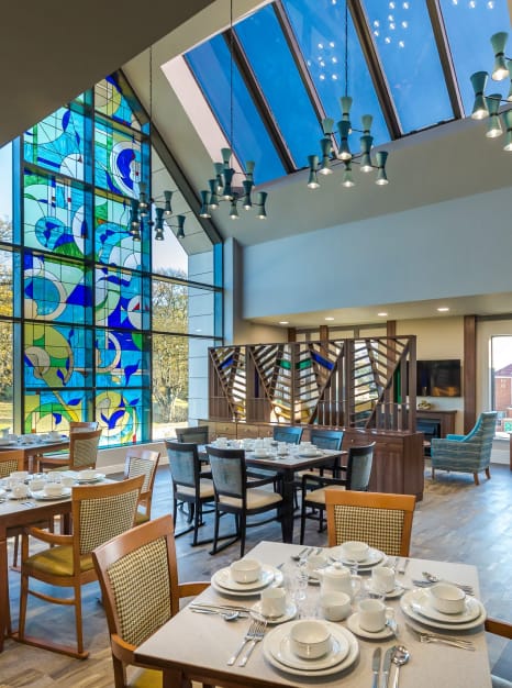 Bright dining room with colorful stained glass window