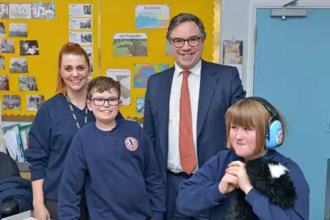 Staff and children posing in a facility environment.