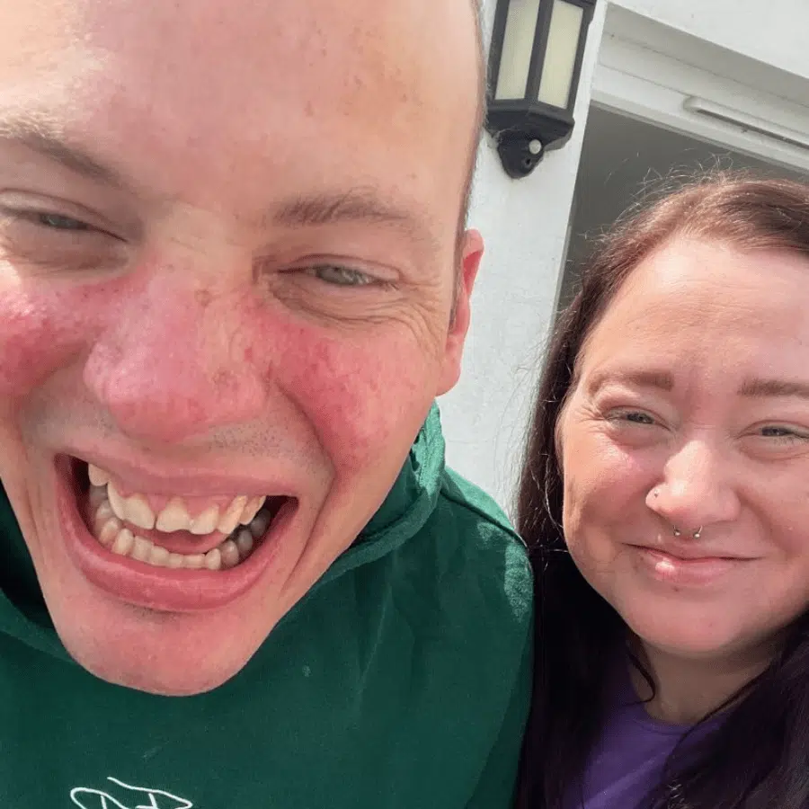 Two residents smiling together outdoors