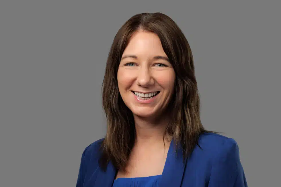 Smiling woman in professional attire.