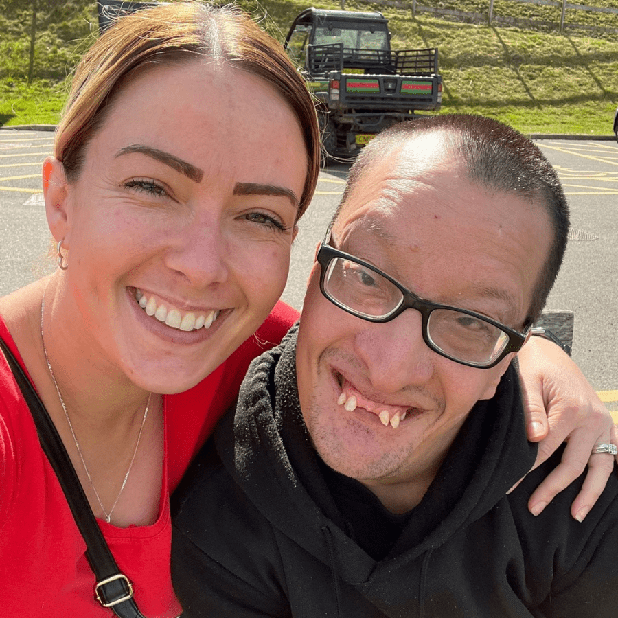 Residents and staff smiling outdoors