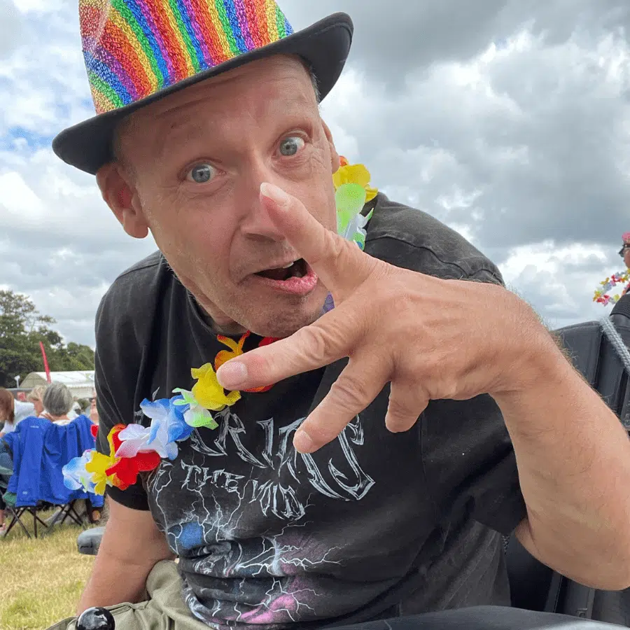 Resident enjoying an outdoor event with colorful attire.