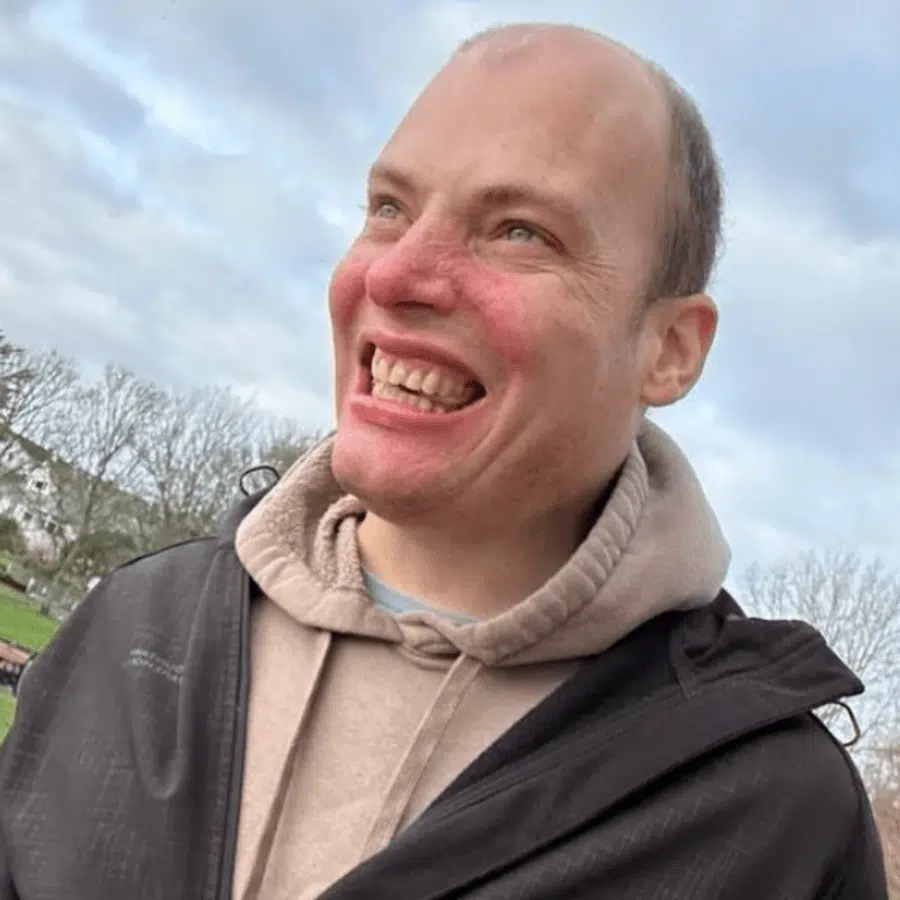 Smiling man outdoors, enjoying the day.