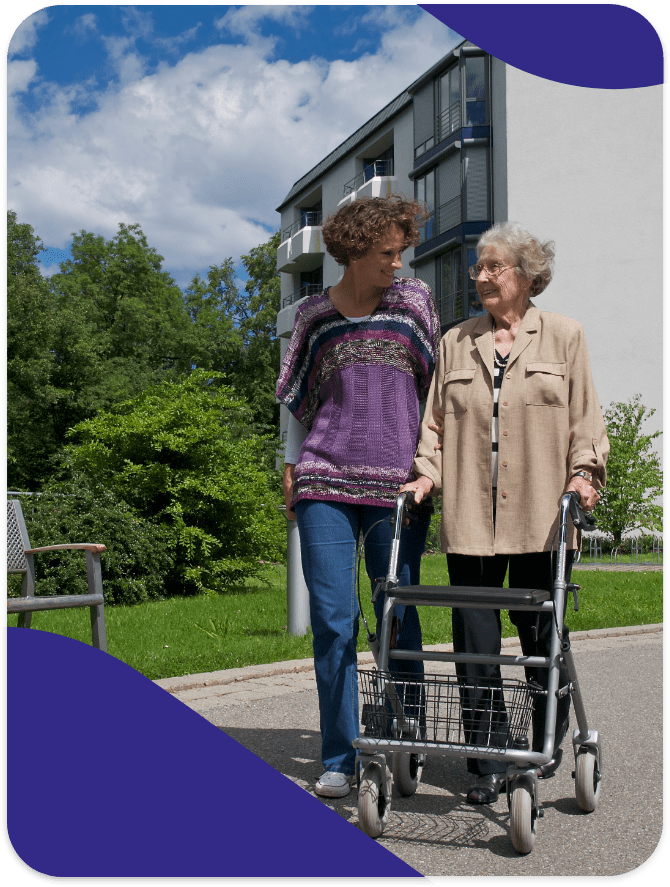 A caregiver assisting a resident outdoors