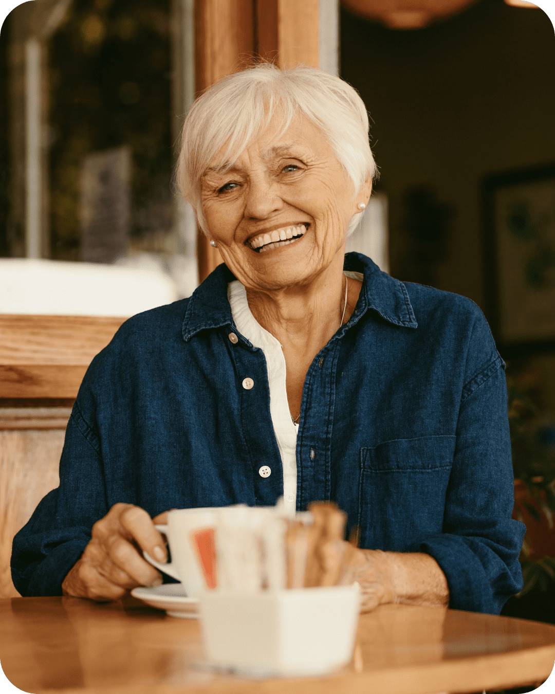 Smiling senior woman enjoying coffee.