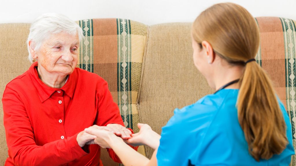 Caregiver assisting an elderly resident with care.
