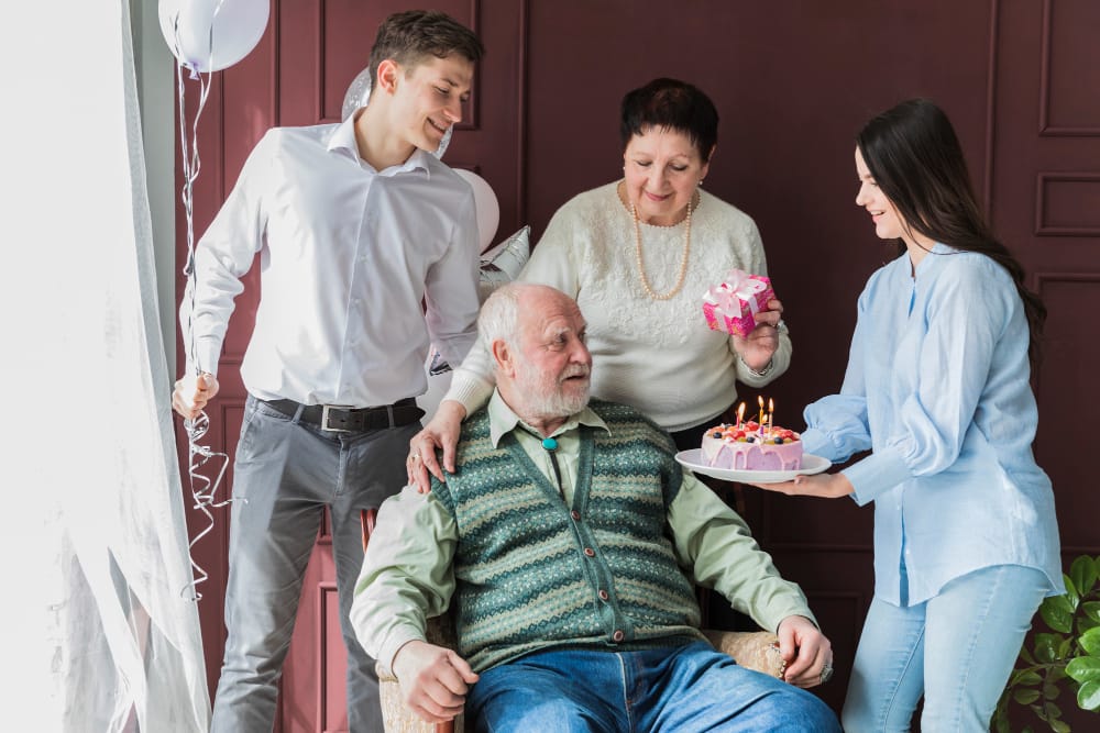 Celebration with residents enjoying a birthday cake.