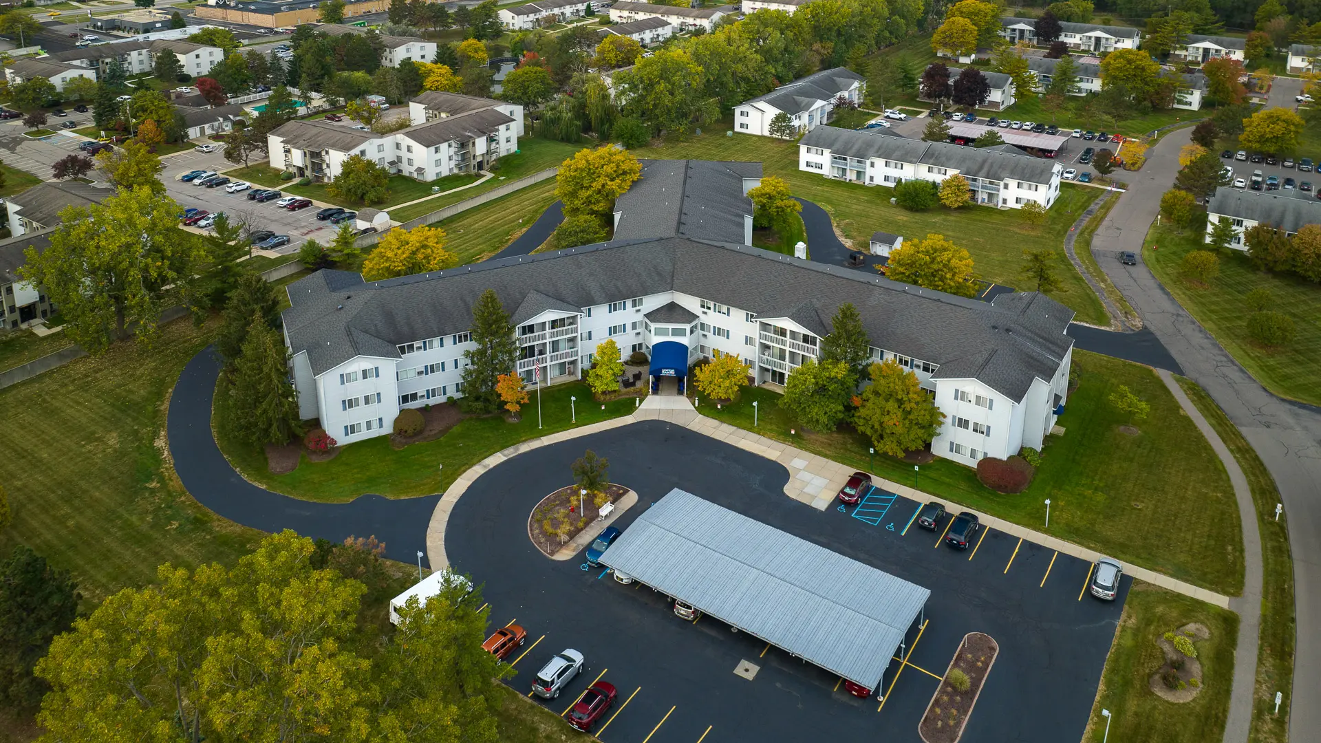 Aerial view of the senior living facility with landscaped grounds