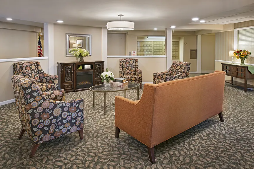 Common area with seating and decor in a senior living facility