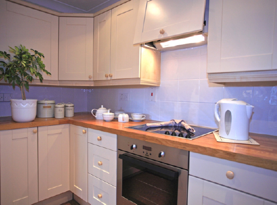 Bright kitchen with modern appliances and decor.