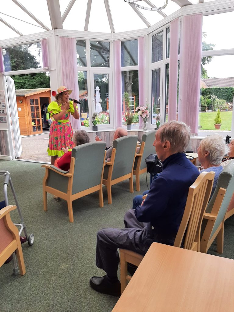 Entertainer performing for residents in activity room