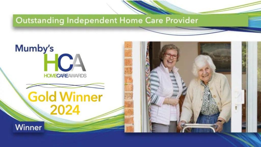 Caregivers and resident celebrating an award