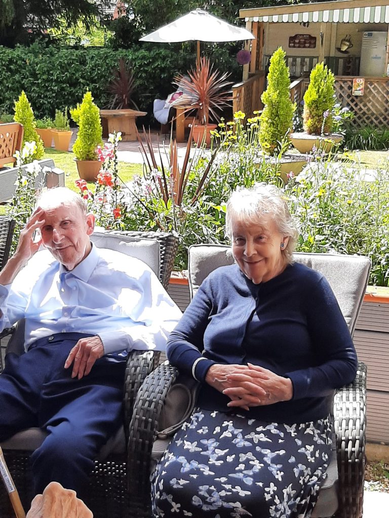 Residents enjoying time in a garden area.