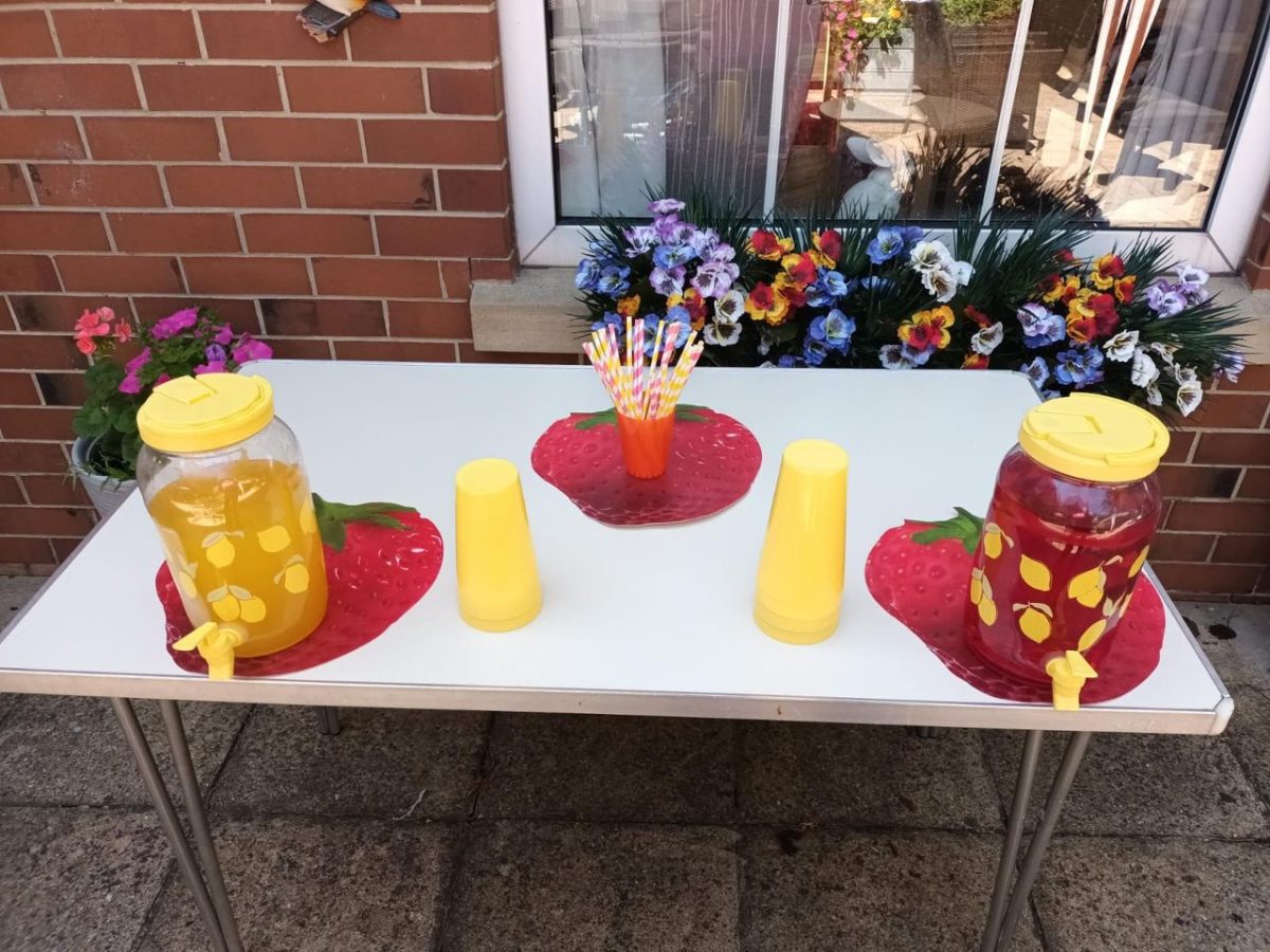 Colorful beverage setup with drinks and cups outside
