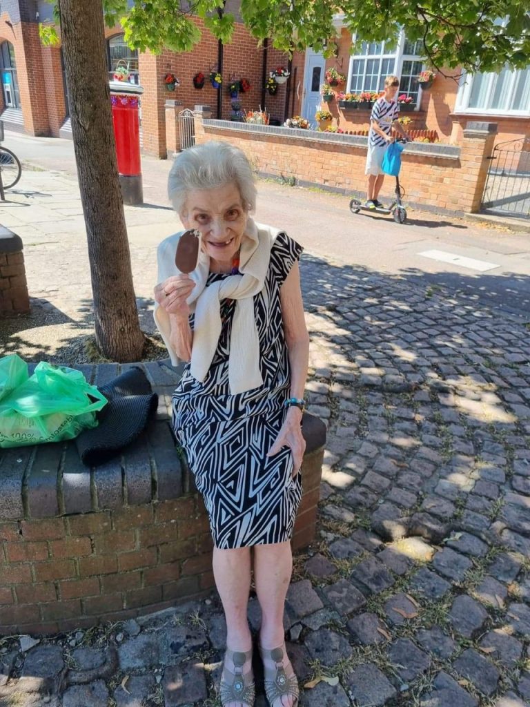 Elderly woman enjoying ice cream outdoors