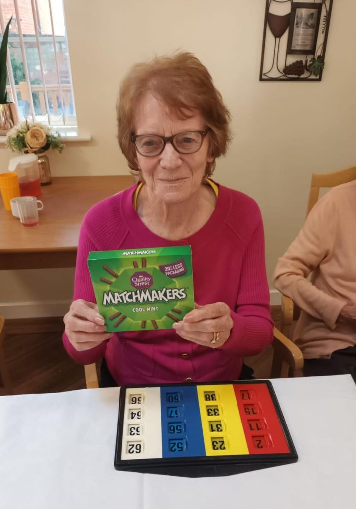 Resident enjoying a game with snacks