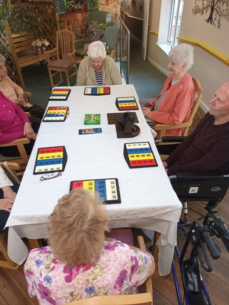 Residents playing a game at a table.