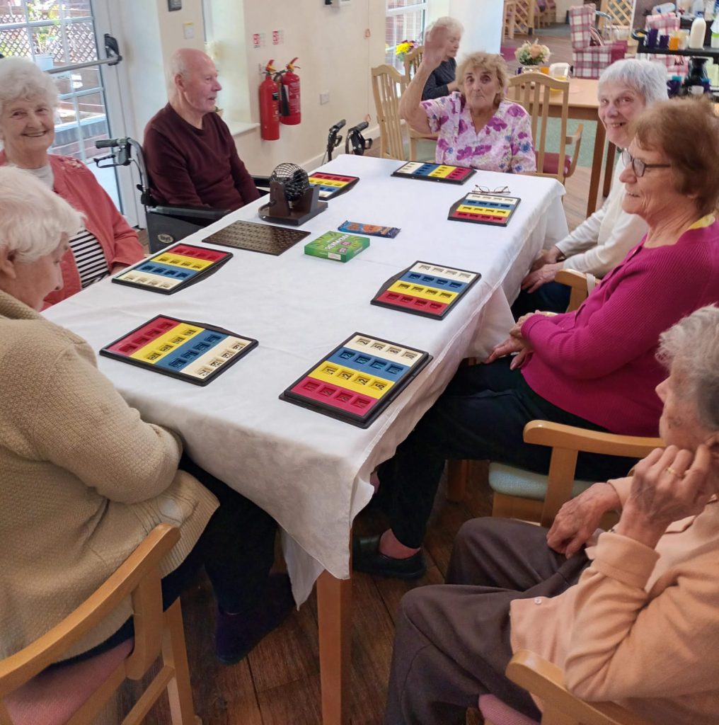Seniors engaged in an activity around a table