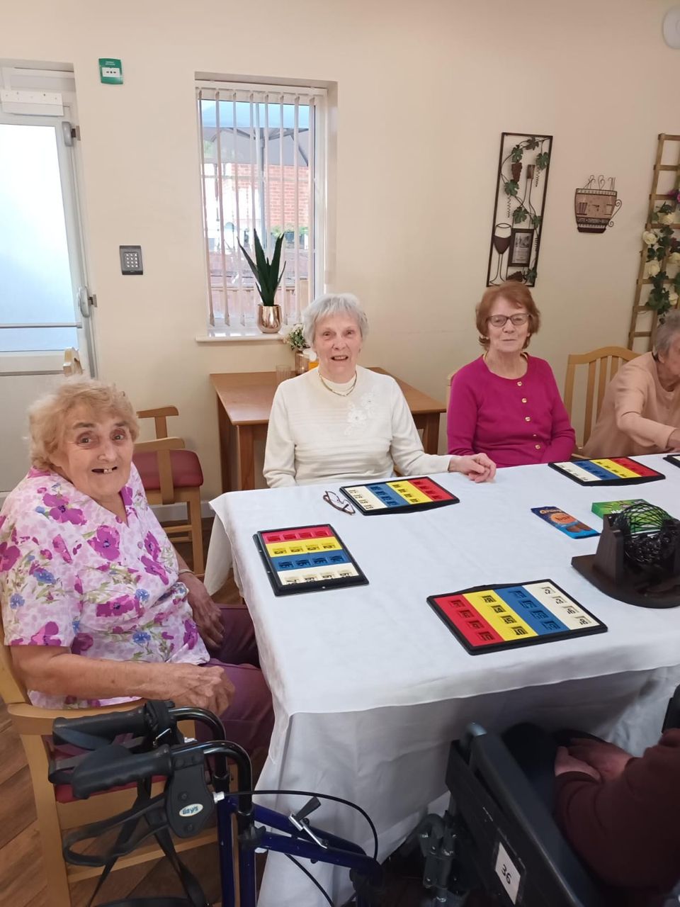 Residents enjoying a game at a communal table.