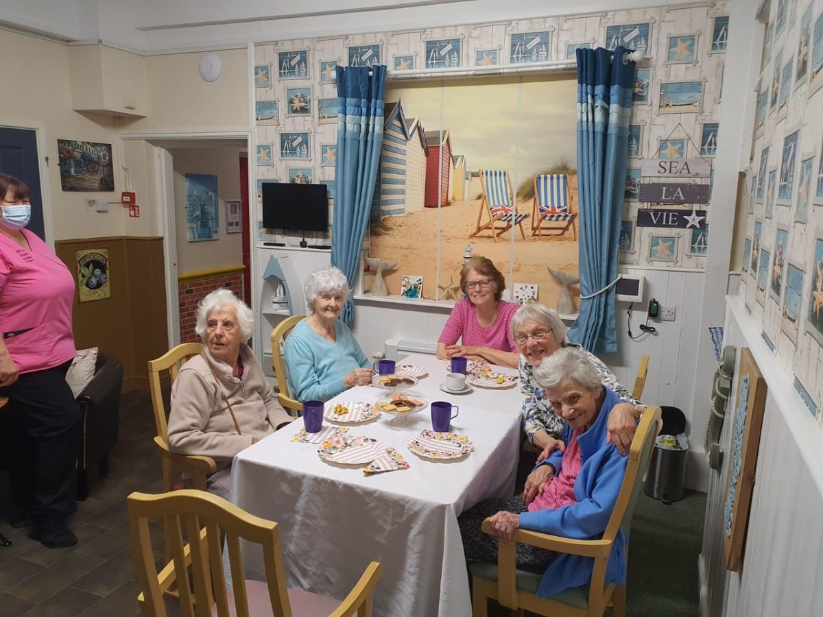 Residents enjoying snacks and drinks at a table