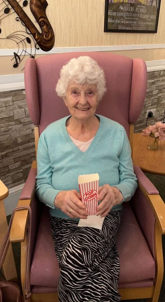 Senior woman enjoying popcorn in a cozy setting