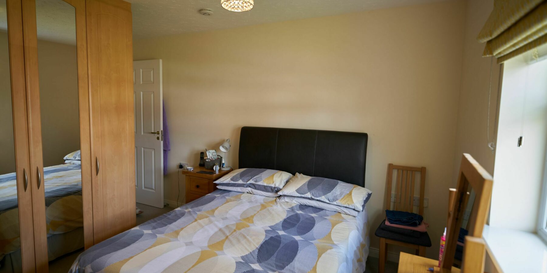 Cozy bedroom with a bed and wardrobe