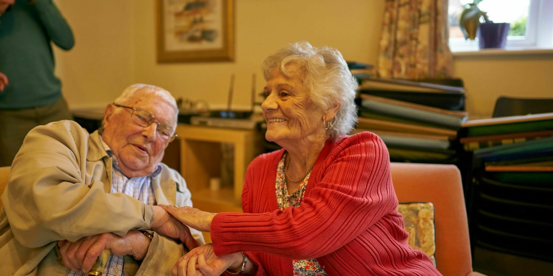 Two residents enjoying a moment together in common area.