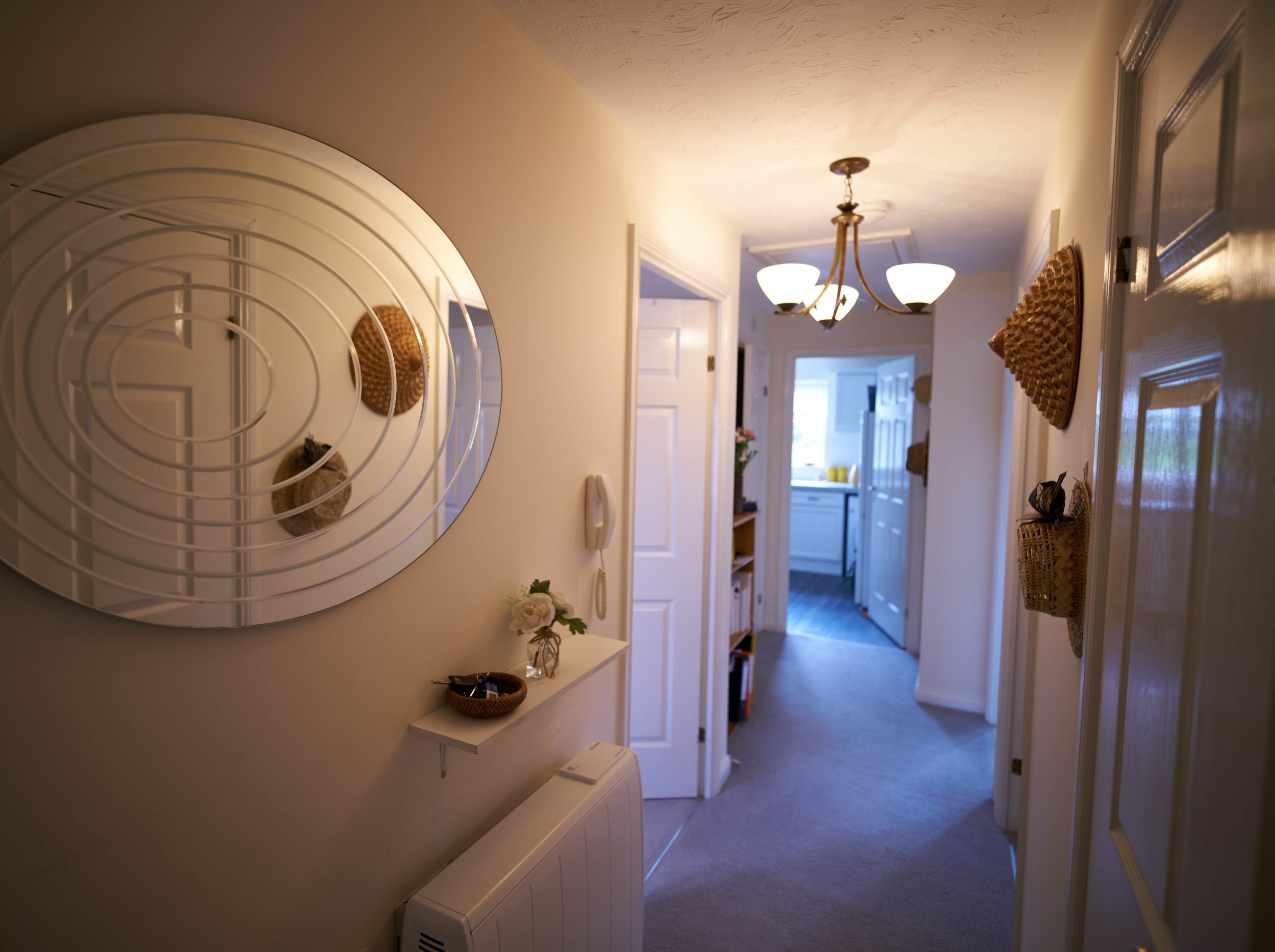 Hallway with decor and lighting fixtures